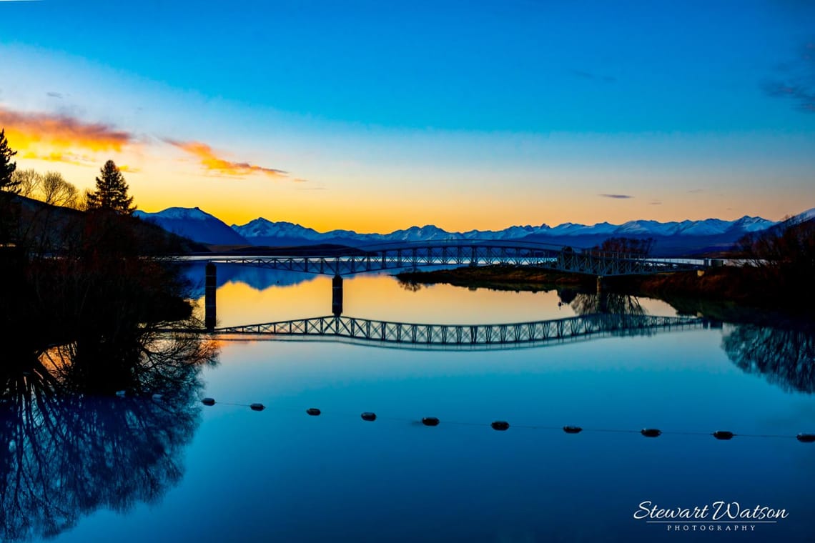 Lake Tekapo footbridge over Scott Pond at sunset